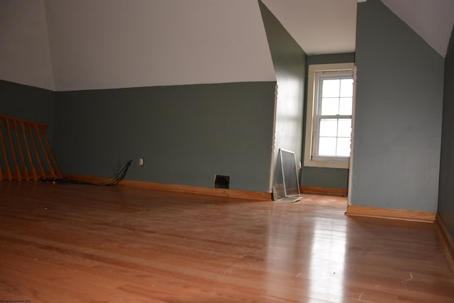 bonus room featuring light hardwood / wood-style flooring and vaulted ceiling