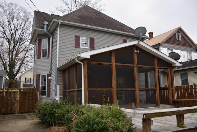 rear view of property with a sunroom