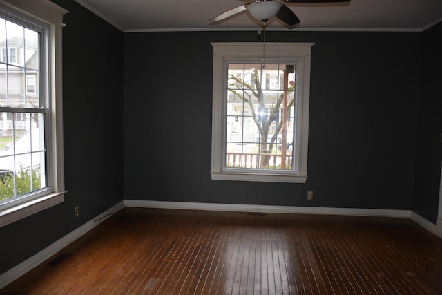 unfurnished room featuring dark hardwood / wood-style floors, ceiling fan, and crown molding