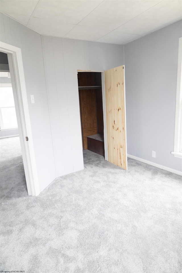 unfurnished bedroom featuring a closet and carpet floors