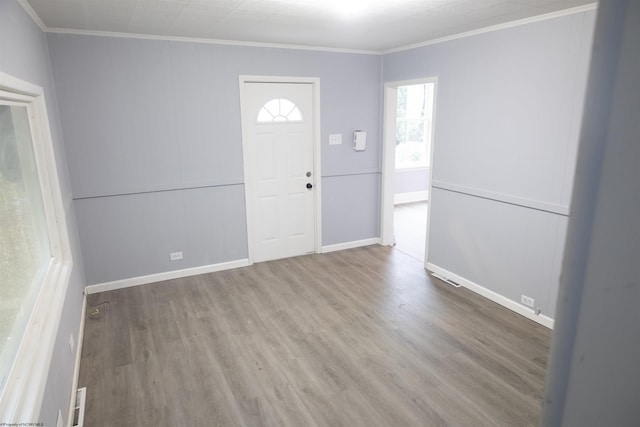 foyer entrance with hardwood / wood-style floors and ornamental molding