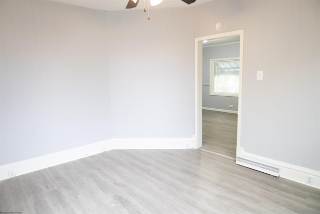 empty room featuring ceiling fan and light hardwood / wood-style floors