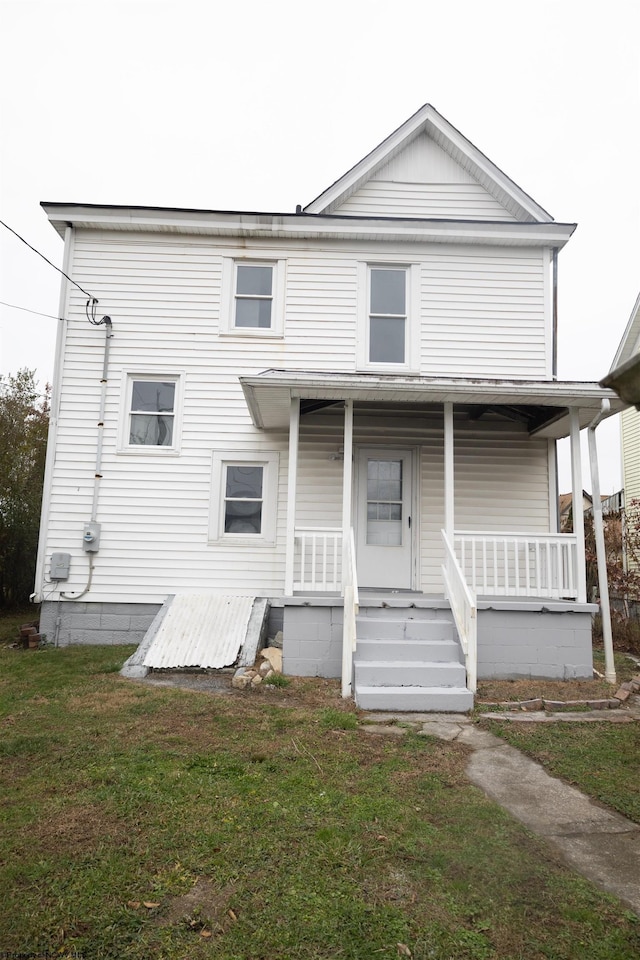 view of front of house with covered porch and a front yard