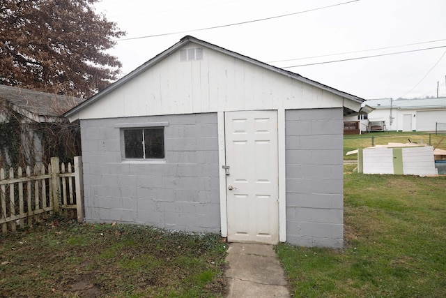 view of outbuilding featuring a lawn