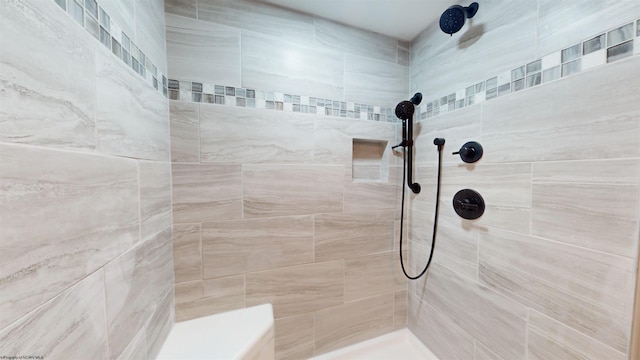 bathroom featuring tiled shower