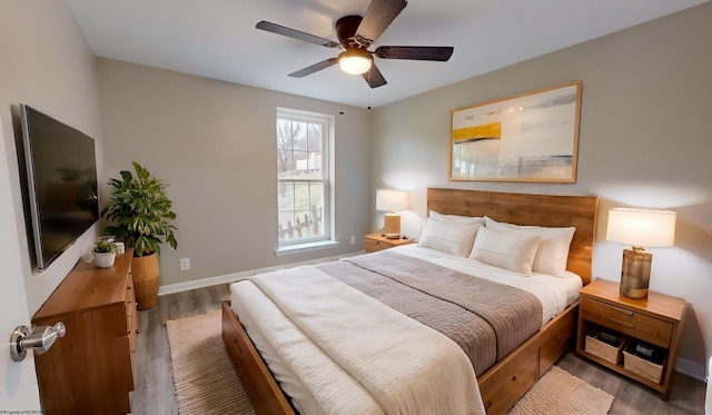 bedroom with hardwood / wood-style floors and ceiling fan