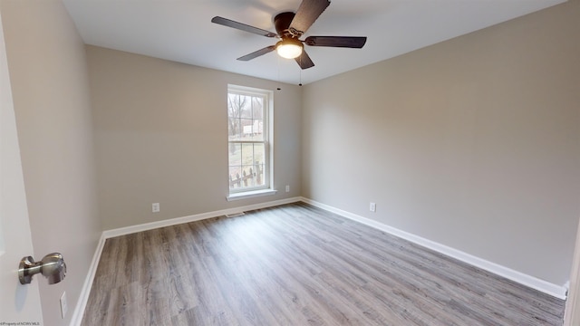 spare room featuring light hardwood / wood-style floors and ceiling fan