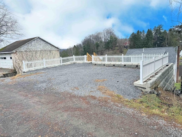 view of yard with a garage and an outdoor structure