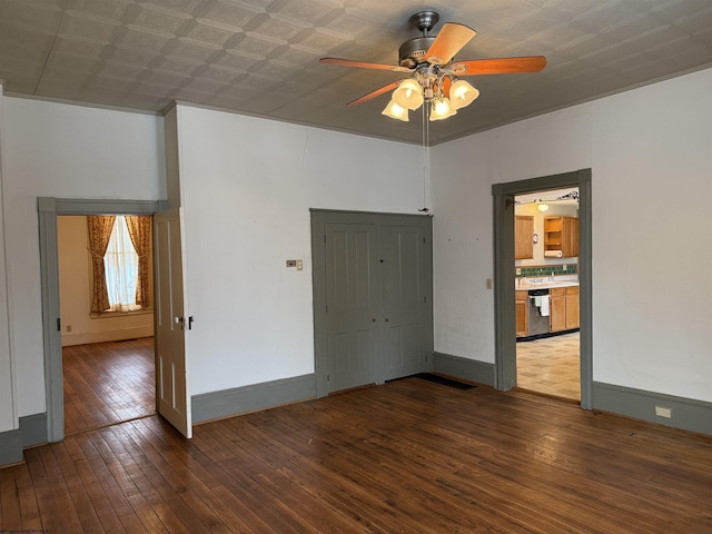 unfurnished room with ceiling fan and dark hardwood / wood-style flooring