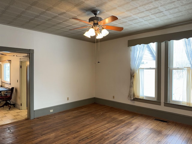 empty room with wood-type flooring and ceiling fan