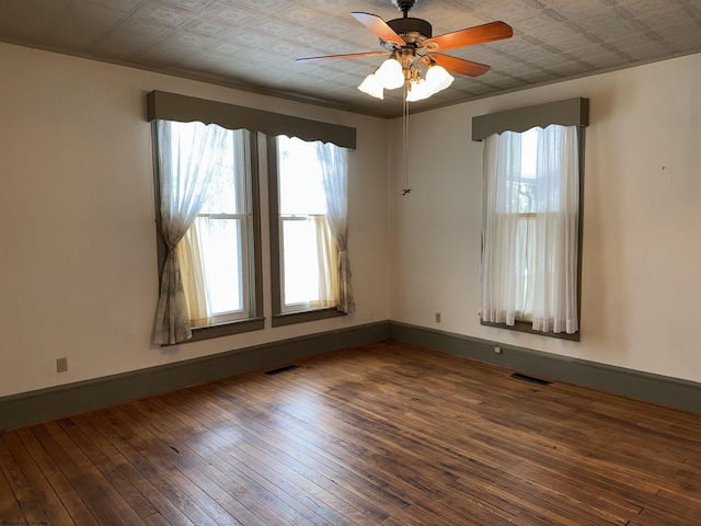 empty room with ceiling fan and wood-type flooring