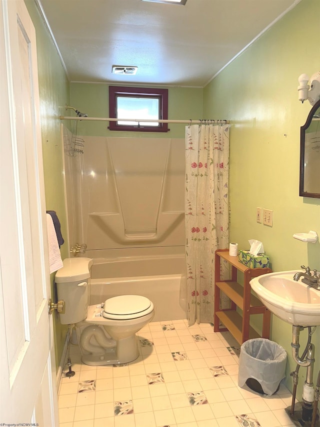 bathroom featuring tile patterned floors, shower / bath combination with curtain, and toilet