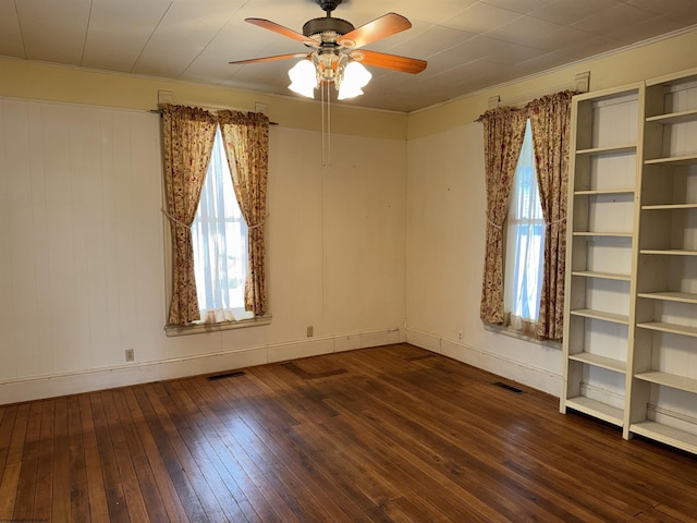 spare room featuring ceiling fan and dark hardwood / wood-style floors