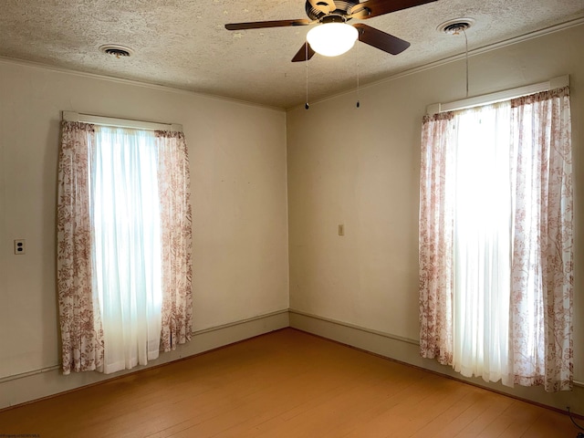 unfurnished room with ceiling fan, plenty of natural light, and light wood-type flooring