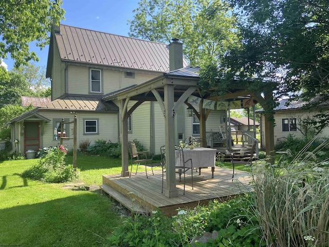 rear view of property featuring a yard and a deck