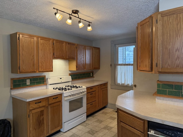 kitchen featuring a textured ceiling and gas range gas stove