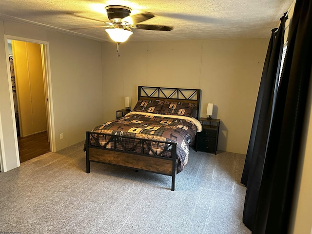 carpeted bedroom with ceiling fan and a textured ceiling