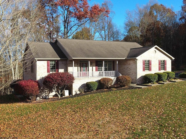 ranch-style house with covered porch and a front yard