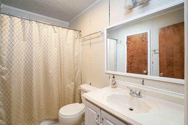 bathroom with a textured ceiling, vanity, toilet, and crown molding