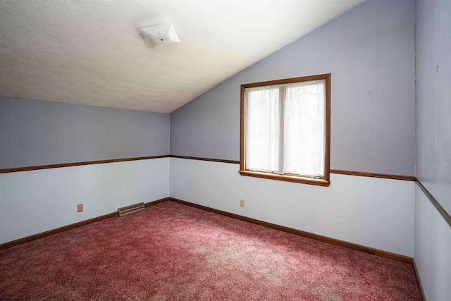 bonus room with carpet floors and vaulted ceiling