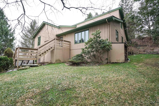 rear view of property with a yard and a deck