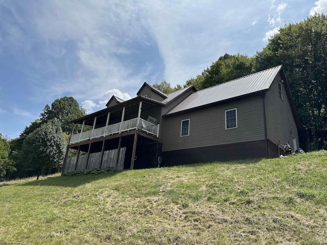 rear view of house featuring a yard and a deck