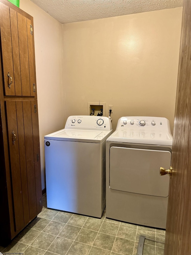 clothes washing area featuring washer and dryer and a textured ceiling