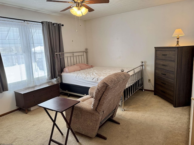 carpeted bedroom featuring multiple windows and ceiling fan