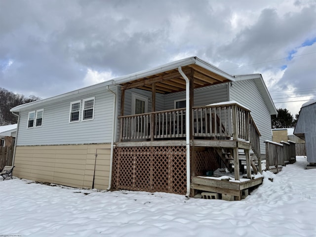 view of snow covered rear of property