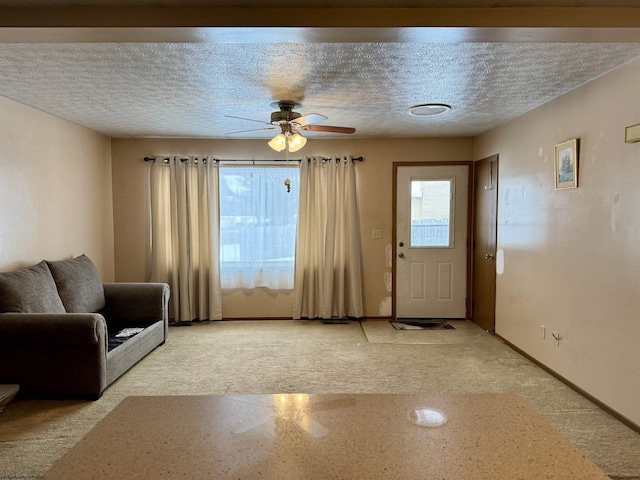 interior space with ceiling fan and a textured ceiling