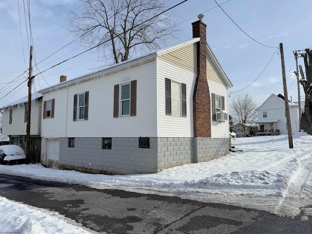 snow covered property featuring cooling unit