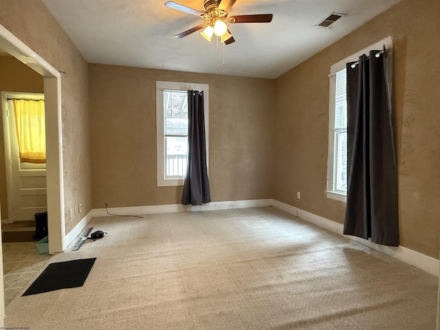 carpeted empty room featuring ceiling fan