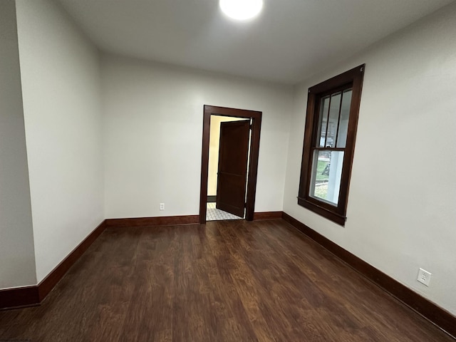 unfurnished room featuring dark hardwood / wood-style flooring