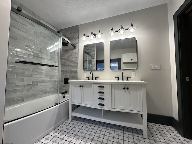 bathroom featuring vanity, a textured ceiling, and enclosed tub / shower combo