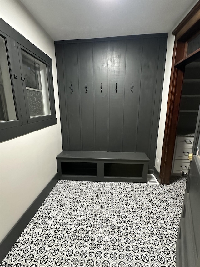 mudroom featuring wood walls