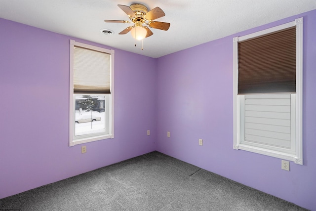 spare room featuring carpet floors and ceiling fan