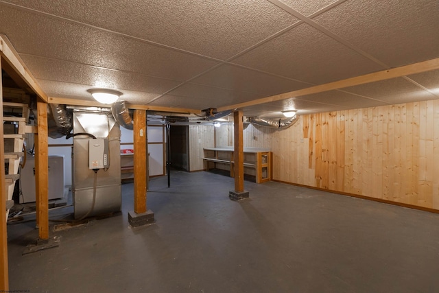 basement featuring wood walls