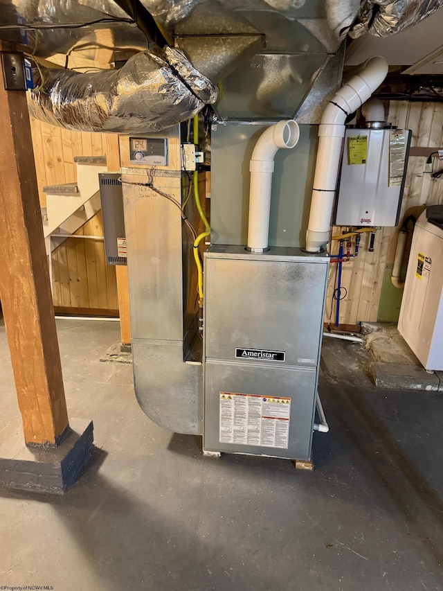 utility room featuring water heater