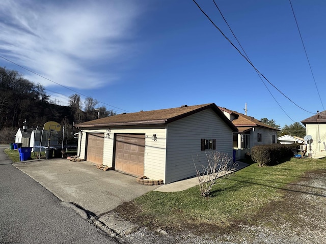 garage featuring a yard and a trampoline