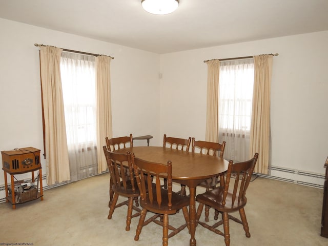 carpeted dining area featuring a baseboard radiator