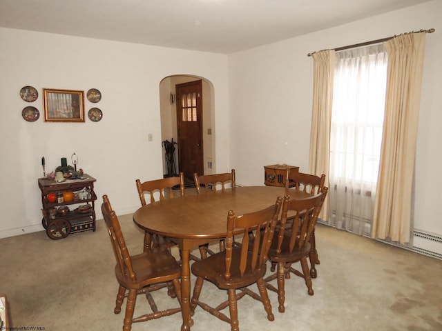 dining area with a healthy amount of sunlight and light carpet