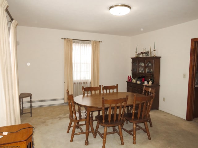 carpeted dining area featuring baseboard heating