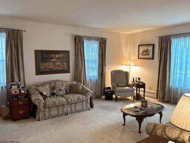 living room featuring a baseboard heating unit and light colored carpet