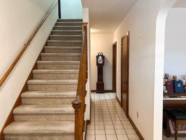 staircase featuring tile patterned floors