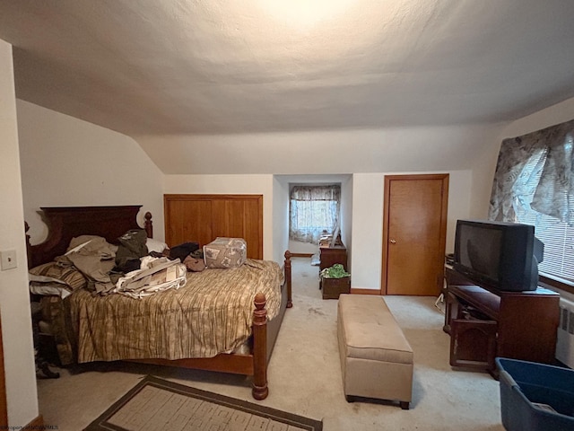 bedroom with light carpet and vaulted ceiling