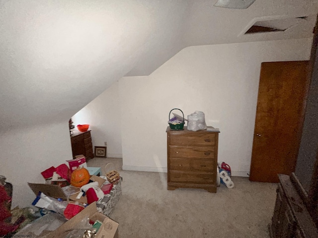 interior space with lofted ceiling and light colored carpet