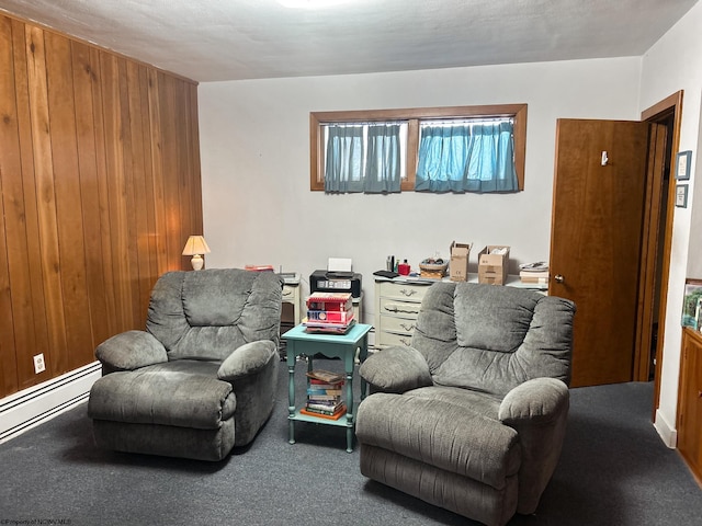 living room featuring wooden walls, a baseboard radiator, and carpet flooring