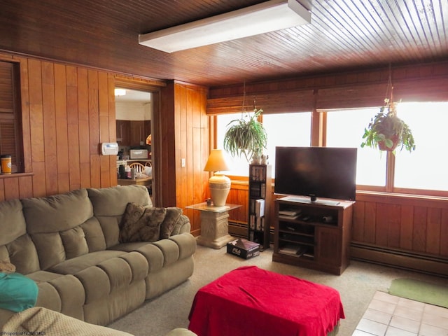 carpeted living room featuring wood walls, a baseboard radiator, and wood ceiling