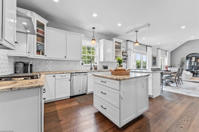 kitchen with stainless steel appliances, a center island, white cabinets, and hanging light fixtures