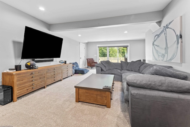 living room with beam ceiling and light colored carpet